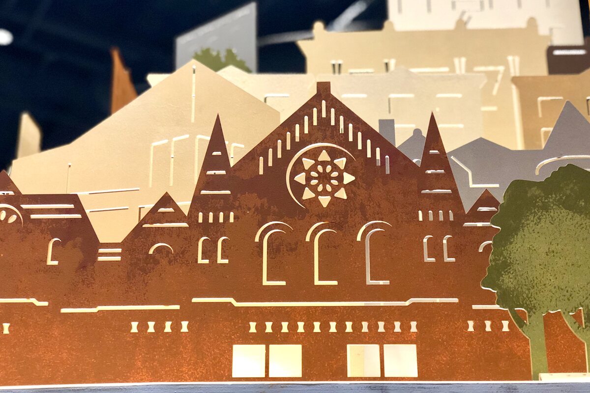 Detail of the Music Hall silhouette, its rose window rendered in rust tones